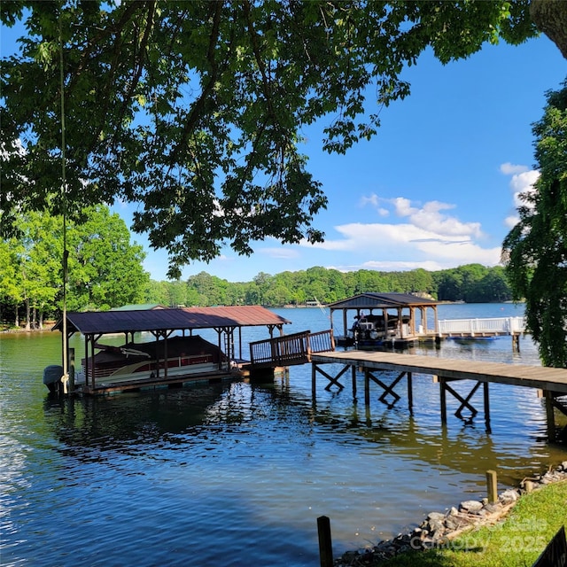 221 Stillwater Rd, Troutman, NC 28166 - dock with boat lift, a water view, and a forest view