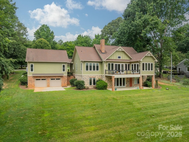 221 Stillwater Rd, Troutman, NC 28166 - rear view of property with a chimney, an attached garage, a yard, and a patio