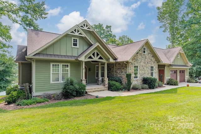 221 Stillwater Rd, Troutman, NC 28166 - craftsman house featuring board and batten siding, a front yard, a porch, and an attached garage