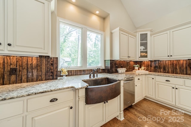 221 Stillwater Rd, Troutman, NC 28166 - kitchen featuring dishwasher, healthy amount of natural light, lofted ceiling, glass insert cabinets, and light stone countertops
