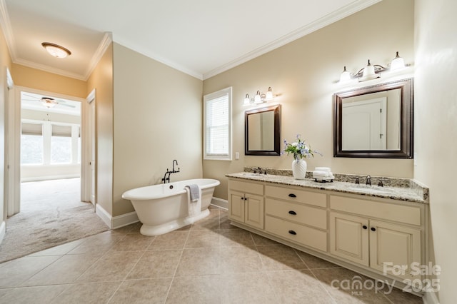221 Stillwater Rd, Troutman, NC 28166 - full bathroom with double vanity, a freestanding bath, healthy amount of natural light, ornamental molding, and tile patterned floors