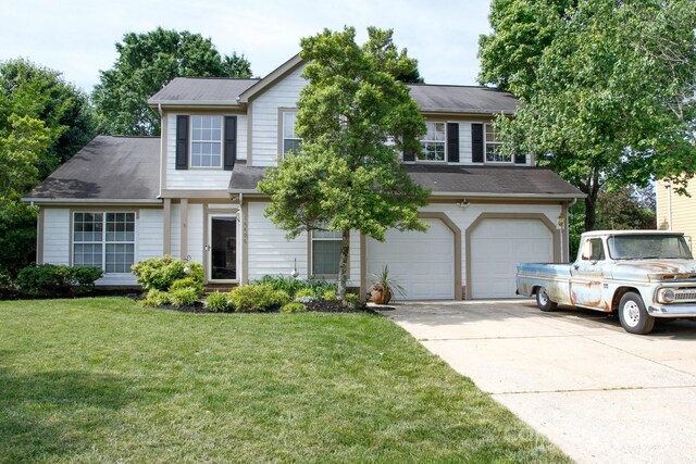 traditional-style home featuring driveway, a garage, and a front yard