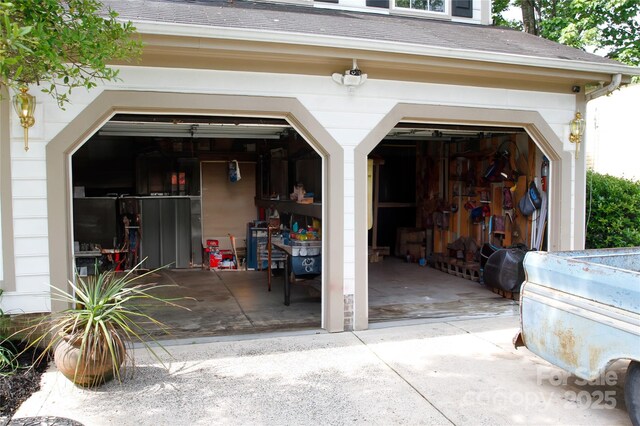 garage featuring concrete driveway