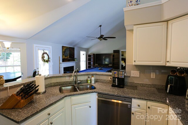 kitchen with dishwasher, a sink, plenty of natural light, a ceiling fan, and lofted ceiling