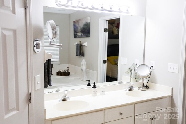 ensuite bathroom with double vanity and a bathtub