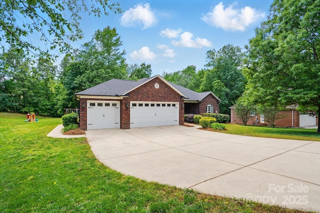 view of front of home with concrete driveway, a front yard, brick siding, and an attached garage