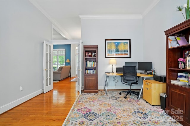 home office featuring french doors, ornamental molding, light wood-type flooring, and baseboards