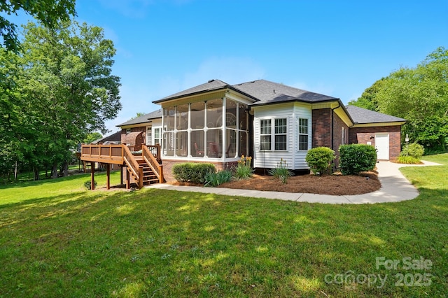 back of house with a sunroom, a wooden deck, a yard, and stairway