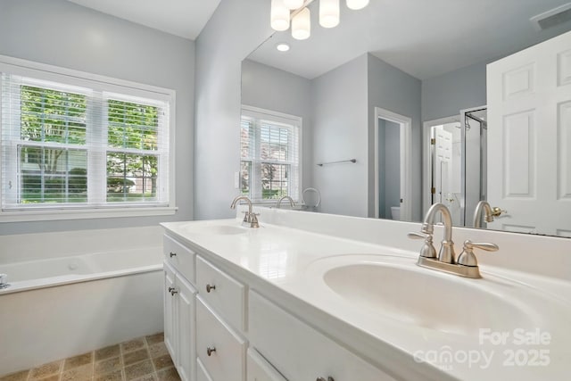 bathroom featuring double vanity, a bath, toilet, a chandelier, and a shower stall