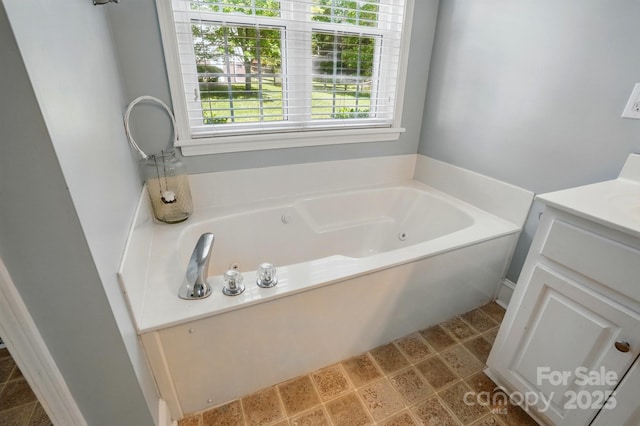 bathroom featuring a jetted tub and vanity