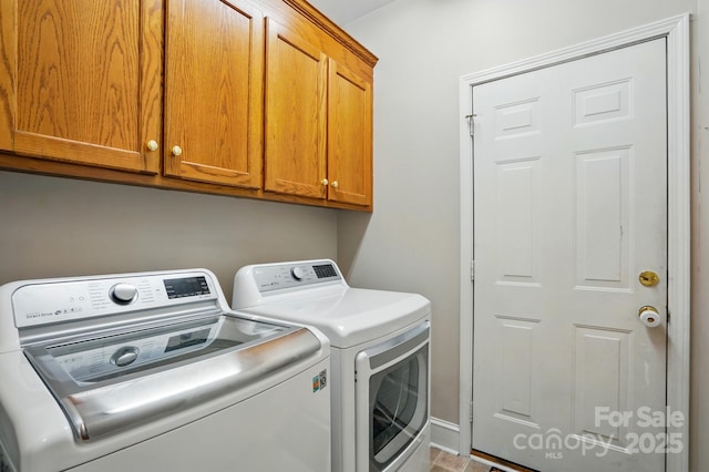 clothes washing area with cabinet space and independent washer and dryer