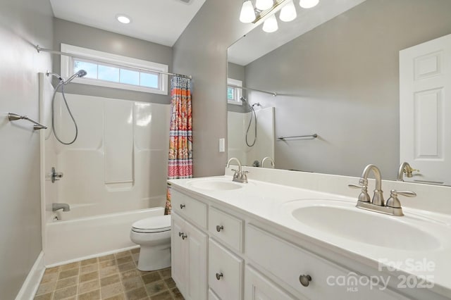 full bathroom with shower / tub combo with curtain, toilet, double vanity, and baseboards