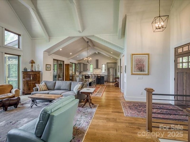 2054 Catawba Trl Unit 162, Nebo, NC 28761 - living area featuring a chandelier, beamed ceiling, light wood-style floors, high vaulted ceiling, and baseboards