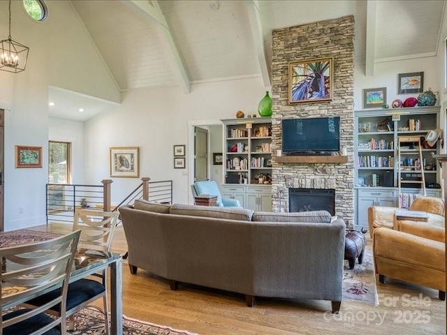2054 Catawba Trl Unit 162, Nebo, NC 28761 - living room featuring high vaulted ceiling, light wood finished floors, a stone fireplace, a chandelier, and beam ceiling
