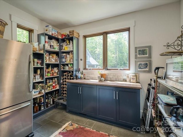 2054 Catawba Trl Unit 162, Nebo, NC 28761 - kitchen with freestanding refrigerator, backsplash, blue cabinetry, and light countertops