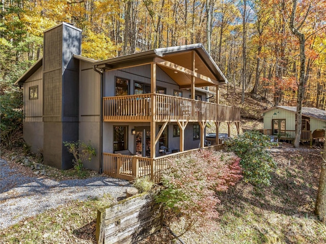 466 Hanging Rock Rd, Mars Hill, NC 28754 - back of property with an outdoor structure, a chimney, a deck, and a forest view