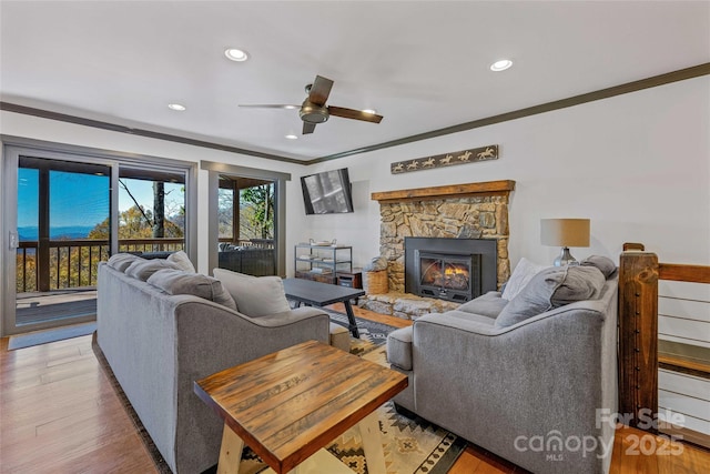 466 Hanging Rock Rd, Mars Hill, NC 28754 - living area with crown molding, a stone fireplace, a ceiling fan, recessed lighting, and light wood-type flooring