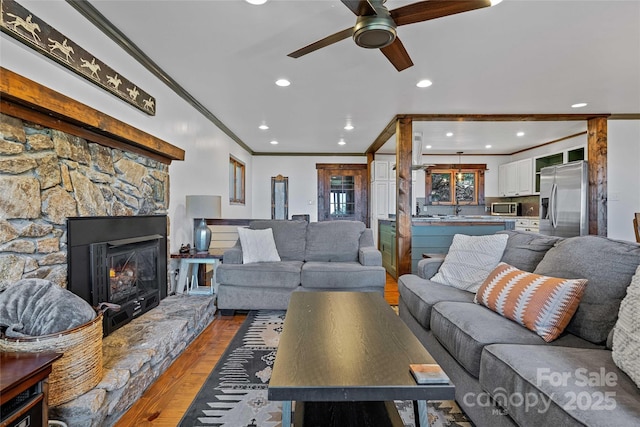 466 Hanging Rock Rd, Mars Hill, NC 28754 - living area with crown molding, ceiling fan, light wood-type flooring, recessed lighting, and a stone fireplace