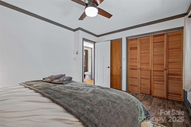 466 Hanging Rock Rd, Mars Hill, NC 28754 - bedroom with a textured ceiling, wood finished floors, two closets, ceiling fan, and ornamental molding