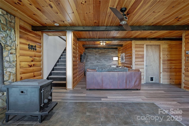 466 Hanging Rock Rd, Mars Hill, NC 28754 - living area with a wood stove, log walls, wooden ceiling, stairway, and beamed ceiling