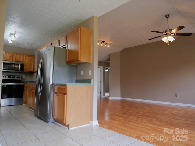 37 S Woodridge View Ct, Hendersonville, NC 28791 - kitchen with appliances with stainless steel finishes, open floor plan, track lighting, a textured ceiling, and light tile patterned floors