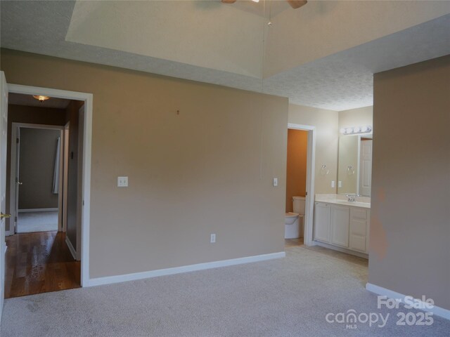 37 S Woodridge View Ct, Hendersonville, NC 28791 - unfurnished bedroom featuring light colored carpet, a sink, baseboards, and connected bathroom