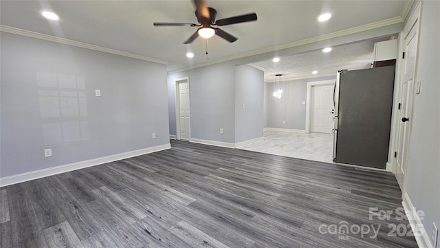 empty room with ornamental molding, ceiling fan, recessed lighting, wood finished floors, and baseboards
