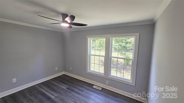 spare room featuring baseboards, ceiling fan, dark wood-type flooring, and ornamental molding