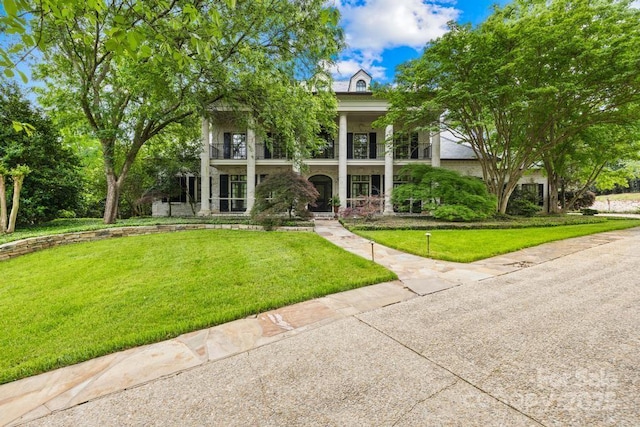 4523 Fox Brook Ln, Charlotte, NC 28211 - greek revival house with a balcony, covered porch, and a front lawn