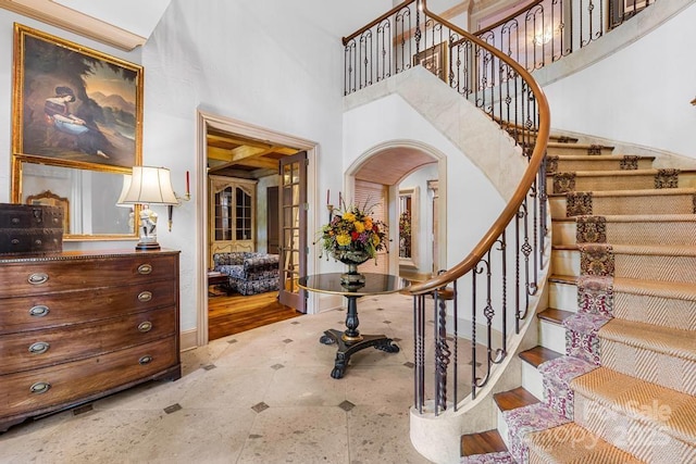 4523 Fox Brook Ln, Charlotte, NC 28211 - entrance foyer with stairs, baseboards, a towering ceiling, and arched walkways