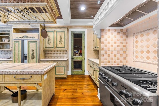 4523 Fox Brook Ln, Charlotte, NC 28211 - kitchen featuring stainless steel range, range hood, dark wood-style flooring, recessed lighting, and backsplash