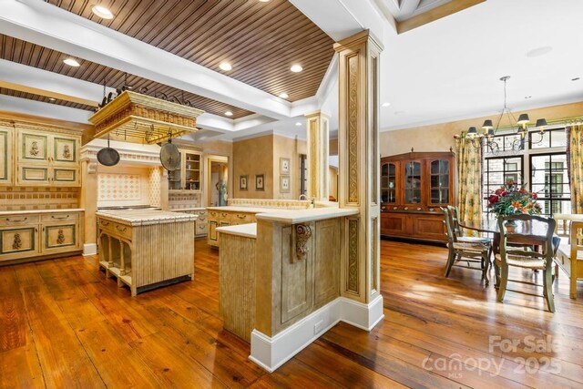 4523 Fox Brook Ln, Charlotte, NC 28211 - kitchen featuring light countertops, a center island, dark wood-style flooring, a chandelier, and beamed ceiling