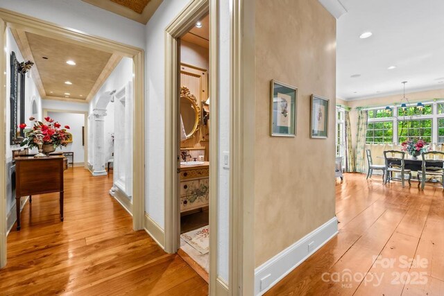 4523 Fox Brook Ln, Charlotte, NC 28211 - corridor with light wood-style floors, baseboards, a sink, ornamental molding, and recessed lighting