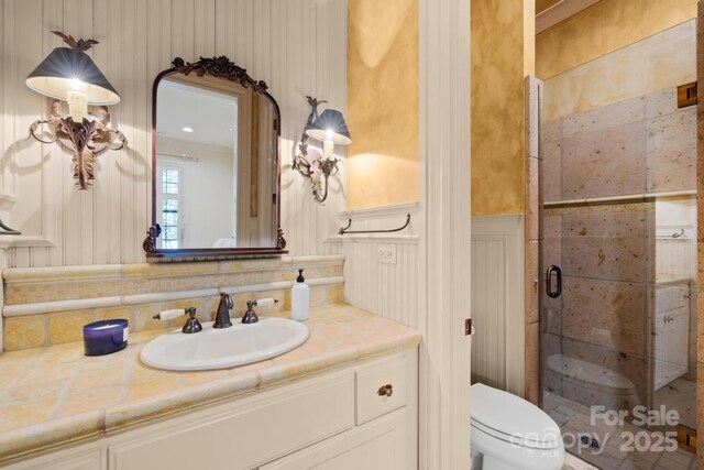 4523 Fox Brook Ln, Charlotte, NC 28211 - full bath featuring a stall shower, vanity, toilet, and a wainscoted wall