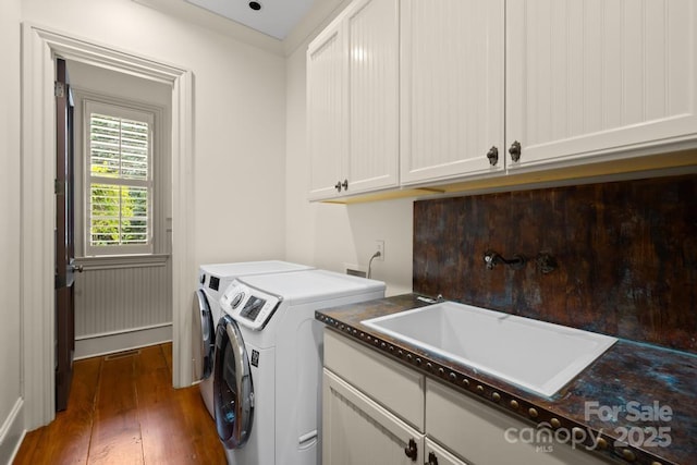 4523 Fox Brook Ln, Charlotte, NC 28211 - washroom with separate washer and dryer, wood finished floors, and cabinet space
