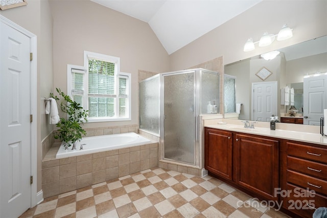 bathroom with vanity, a shower stall, a bath, and lofted ceiling