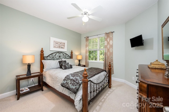 bedroom with light colored carpet, baseboards, and ceiling fan