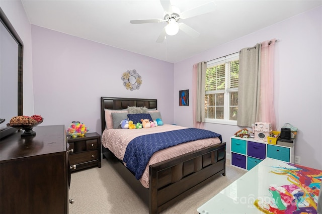 bedroom featuring light carpet and a ceiling fan