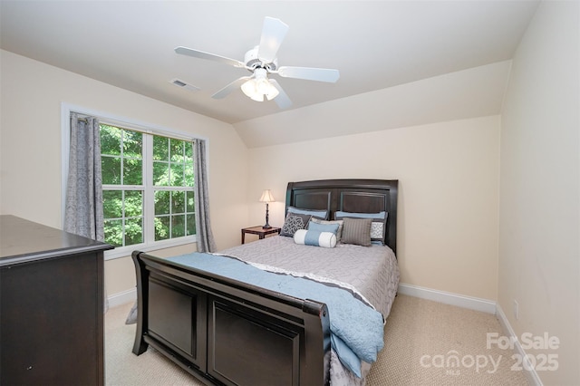 bedroom with light carpet, baseboards, a ceiling fan, and lofted ceiling