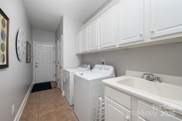 washroom featuring independent washer and dryer, cabinet space, and baseboards