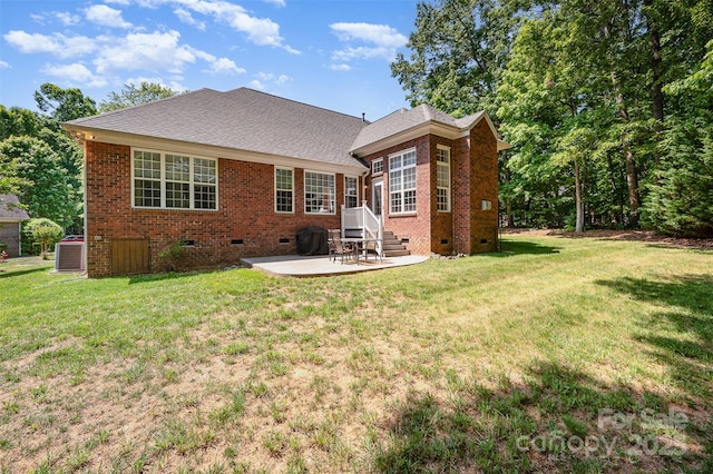 rear view of property with crawl space, brick siding, a patio area, and cooling unit