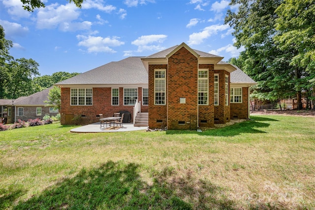 rear view of house featuring crawl space, brick siding, a patio area, and a shingled roof