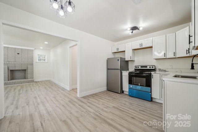 1417 W Monroe St, Salisbury, NC 28144 - kitchen with black / electric stove, a sink, freestanding refrigerator, and light wood-style floors