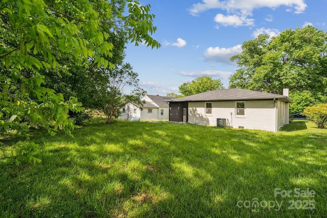 1417 W Monroe St, Salisbury, NC 28144 - rear view of property with a chimney, a yard, cooling unit, and brick siding