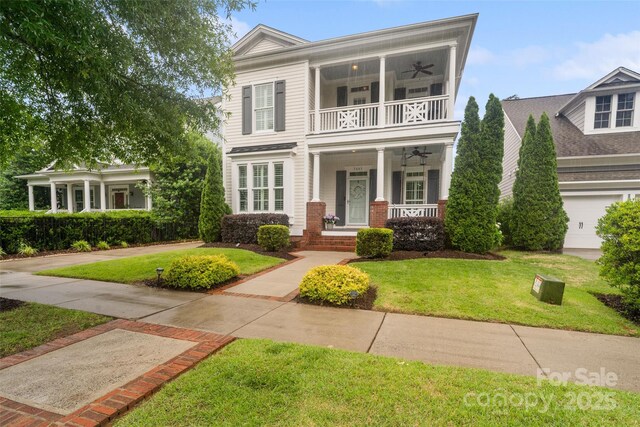5663 Morris Hunt Dr, Fort Mill, SC 29708 - neoclassical home with a balcony, ceiling fan, covered porch, and a front yard