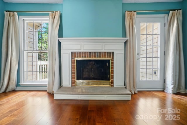 detailed view of a fireplace and wood finished floors