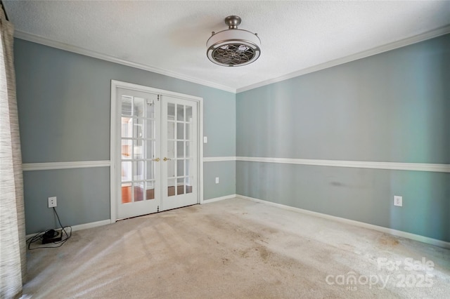 carpeted empty room with french doors, ornamental molding, a textured ceiling, and baseboards
