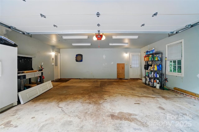 garage with a garage door opener and fridge