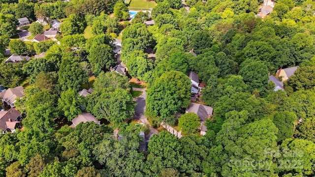 aerial perspective of suburban area with a forest
