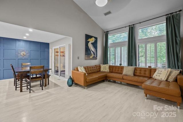 222 Riverview Ter, Clover, SC 29710 - living area with light wood-type flooring, high vaulted ceiling, and a decorative wall